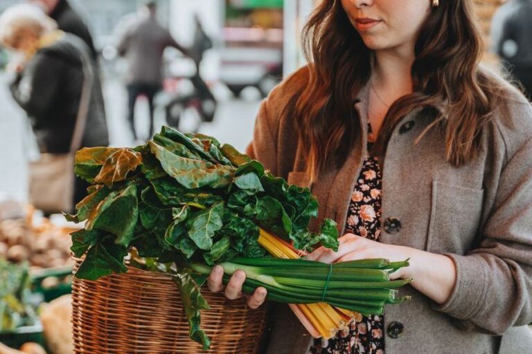 A woman choosing fresh vegetables at a market